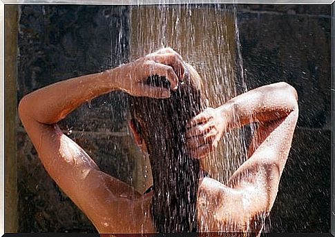 woman-washes-hair-under-the-shower