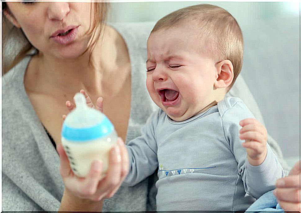 Crying baby with bottle