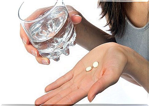 Woman takes pills with water