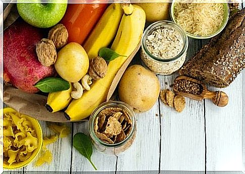 It shows healthy carbohydrates in the form of bananas, walnuts, apples and more.