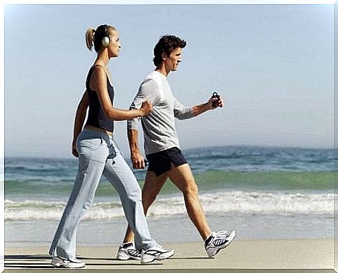 Couple runs on the beach